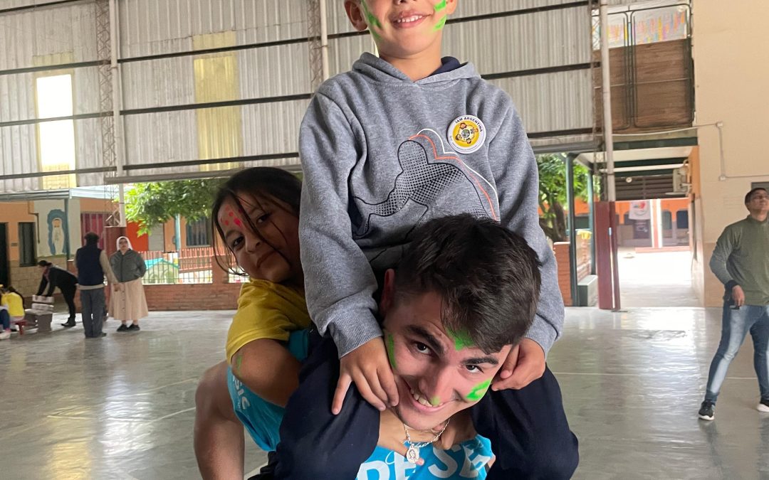 Voluntario de My Mission jugando con niños durante una actividad en Argentina.